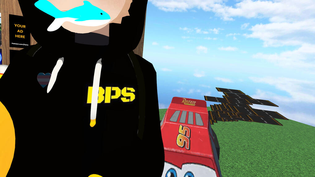 Adam Murray standing next to lightning McQueen with a fish in his mouth